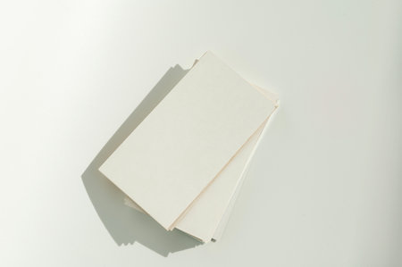 White blank business card on brown paper background with soft shadow. Corporate identity and stationery mockup concept with copy spaceの写真素材