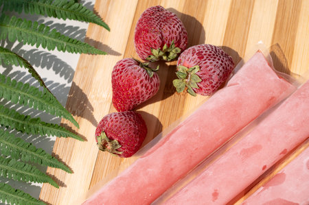 Ice cream in a bag with strawberries - sweet frozen homemade. It is known in Brazil as: Dindin, chup-chup, geladinho or Sokole.の写真素材