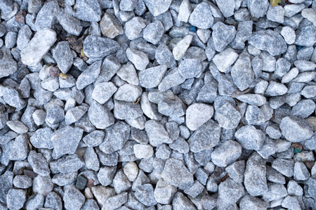 small road stone background, dark gravel, pebbles, stone texture, seamless texture. Gravel texture. Pebble stone background. Light gray stones close up. Top view of a dirt gravel road.の写真素材