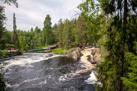 River rapids in a forest landscape with people on a bridge. Nature and travel concept. Design for poster, environmental campaign, and tourism promotionの写真素材