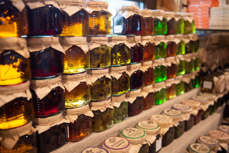 Colorful herbal infusion jars in rows on a market stand. Health and wellness product display conceptの写真素材