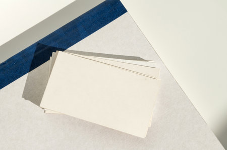 White blank business card on brown paper background with soft shadow. Corporate identity and stationery mockup concept with copy spaceの写真素材
