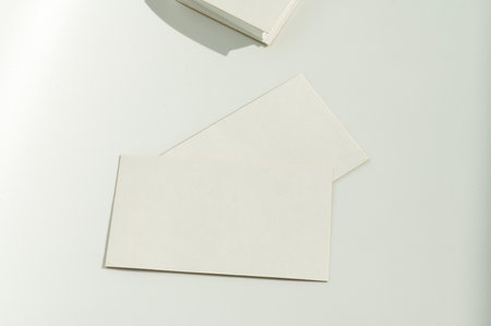 White blank business card on brown paper background with soft shadow. Corporate identity and stationery mockup concept with copy spaceの写真素材