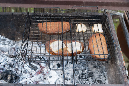 Sizzling fish steaks cook to perfection on an outdoor grill, capturing the essence of a rustic barbecue experienceの写真素材