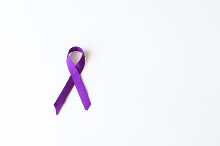 A single purple awareness ribbon on a plain white background, symbolizing various causes and raising awarenessの写真素材