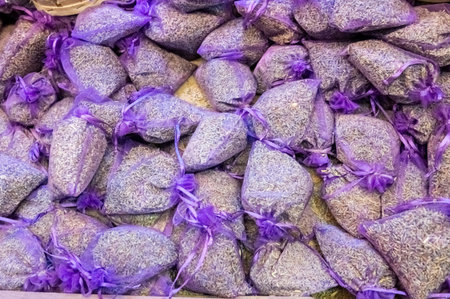 A collection of lavender-filled sachets in delicate purple mesh bags, ideal for aromatherapy or decorative purposes.の写真素材