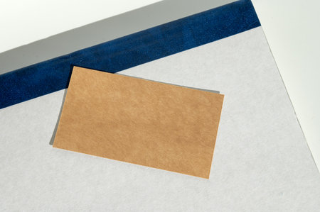 A simple yet elegant composition of layered paper with varying textures, highlighted by soft natural sunlight and geometric shadowsの写真素材