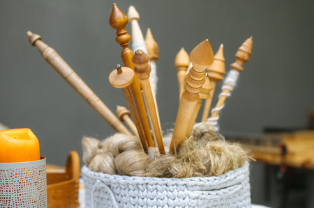 Cozy knitting scene with wooden needles and natural fiber in handwoven basket.