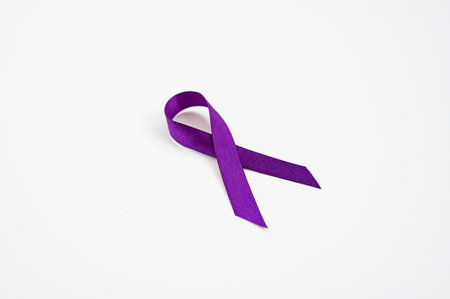 Purple awareness ribbon symbol on white background for Alzheimer's support.の写真素材