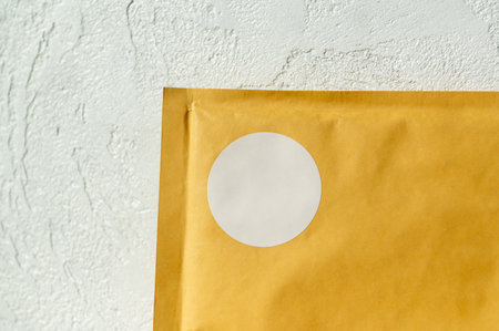 Envelope with white seal on textured wall background.の写真素材