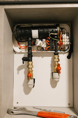 Indoor heating system maintenance with tools and pipes.の写真素材