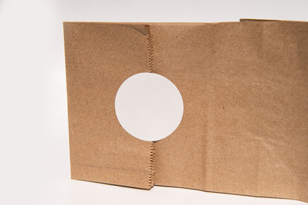 Cardboard box with circular cutout on white background.の写真素材