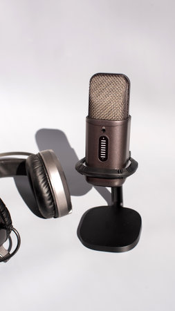 Microphone and headphones set for podcast recording on white background.の写真素材