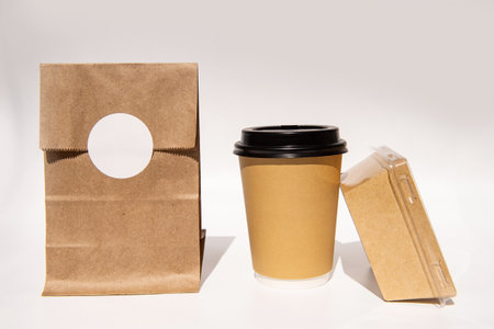 Minimalist eco-friendly brown paper lunch set with coffee cup and sandwich box.