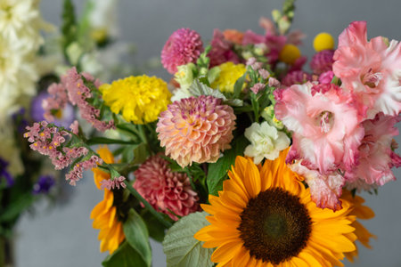 Diverse colorful flowers arrangement featuring sunflowers and dahlias.の写真素材