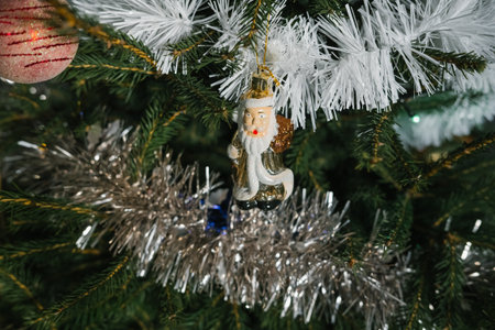 Festive christmas tree with santa ornament and tinsel decorations.の写真素材
