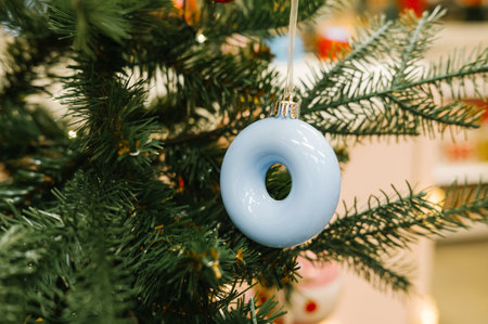 Blue porcelain ornament on green christmas tree branch close-up.の写真素材