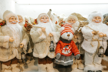 Festive santa figures with bear in sweater display.の写真素材