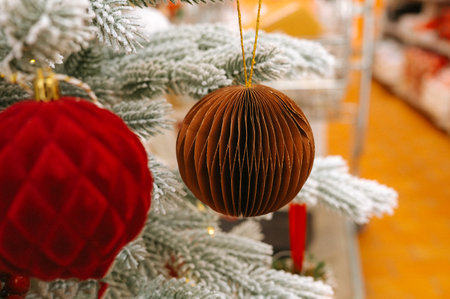 Festive christmas tree with red and brown ornaments and snowy branches.の写真素材