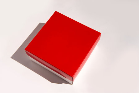 Red square box on white background with subtle shadow.の写真素材