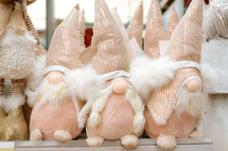 Festive trio of sparkly gnome decorations with glittery hats in holiday display.の写真素材