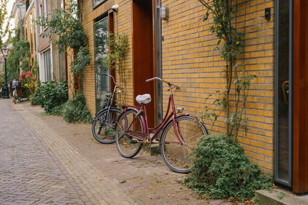 Vintage bicycles parked on quaint european streetscape with brick buildings.の写真素材