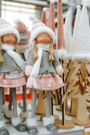 Festive holiday decor featuring dolls in winter-themed outfits and decorative trees.の写真素材