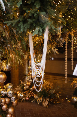 Festive holiday decor with gold ornaments and pearl garland.の写真素材