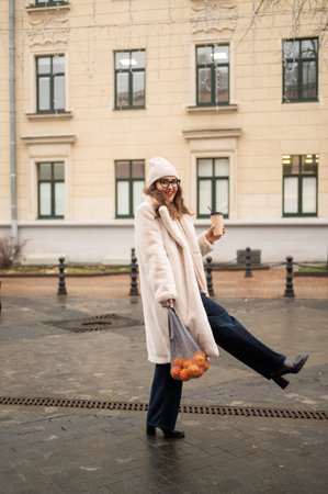 Caucasian female adult in winter fashion enjoying outdoor moment.の写真素材