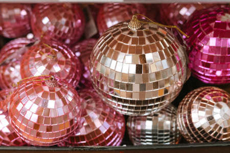 Sparkling pink and silver disco ball christmas ornaments in a box.の写真素材