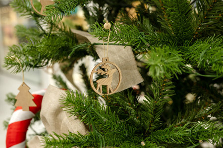 Wooden reindeer ornament on decorated christmas tree with candy cane.の写真素材