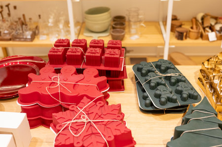 Colorful silicone baking molds displayed on wooden shelves in a store.の写真素材