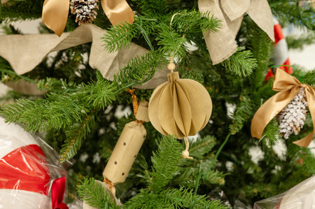 Festive christmas tree with handmade paper ornaments and natural decorations.の写真素材
