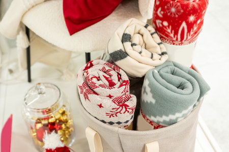 Cozy rolled blankets and festive decorations for winter comfort.の写真素材