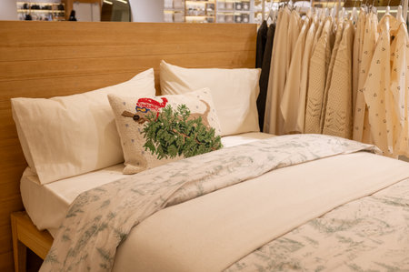 Cozy bedroom decor with patterned pillow and neutral bedding.