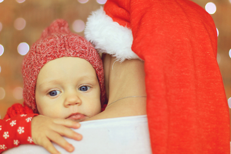 X-mas baby on mothers shoulderの写真素材