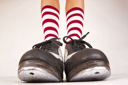 Pair of black and white tap shoes with red and white striped socksの写真素材