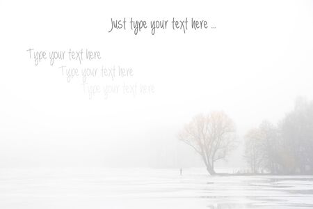 Autumn/Winter foggy background with tree and man for typing your text.の写真素材