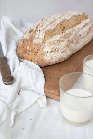 Wheat bread, a jug of milk and bread with sesame seeds