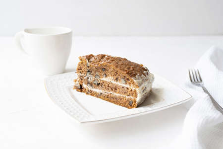 Slice of carrot cake and coffee on white backgroundの写真素材