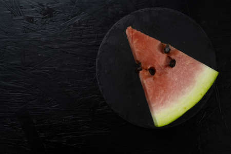 Watermelon on dark table. Sliced watermelon on the black backgroundの写真素材