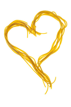Swirls of cooked spaghetti. Spaghetti heart shapeの写真素材
