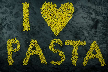 Pasta in the shape of a heart on a black background.の写真素材