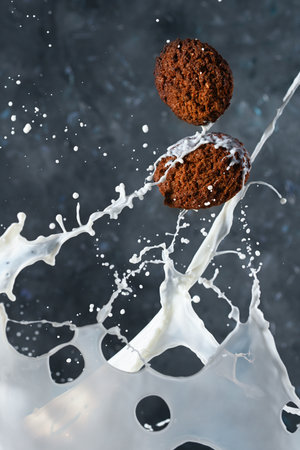 Oatmeal cookies with milk splashes on gray background. levitationの写真素材