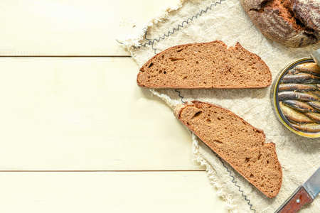 Sandwich with sprats. Sprat in oil. On a wooden background.の写真素材