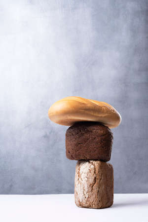 balancing bread on a table on a gray background.