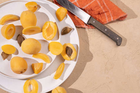 Apricot on beige background. Sliced apricot top view, flat lay, copy spaceの写真素材