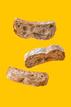 three bread slices levitation on yellow background.