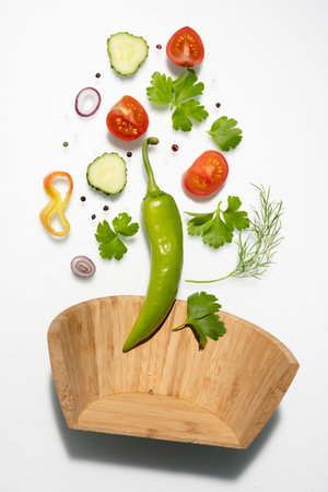 Flying vegetable salad isolated on white background. Healthy eating and lifestyleの写真素材