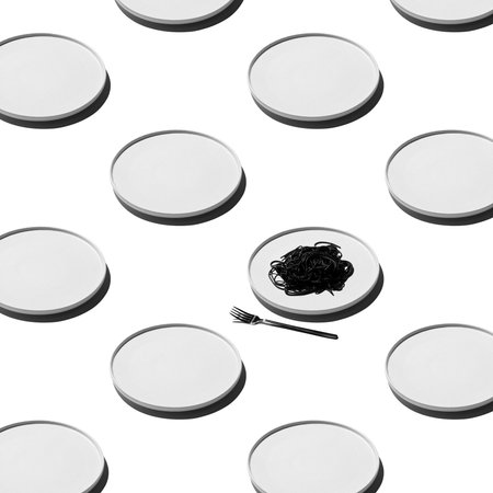 beautifully served black spaghetti in a white plate. Flat lay. Pattern.の写真素材